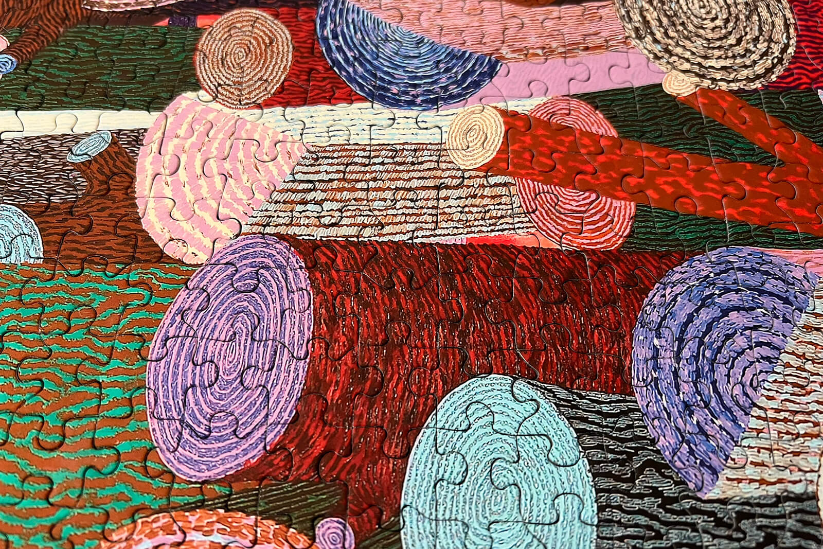 1000-Piece Woodpile Puzzle | Colorful Woodgrain Jigsaw (19.25" x 26.5"), side view